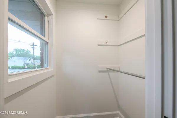a bathroom with a granite countertop toilet sink and mirror