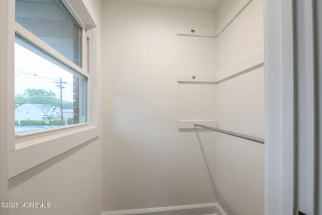 a bathroom with a granite countertop toilet sink and mirror
