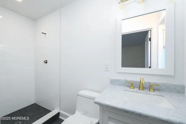 a bathroom with a sink a toilet and vanity