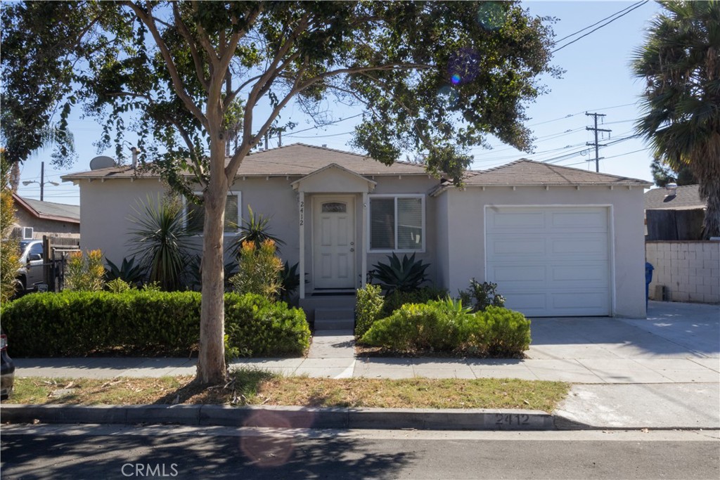 2412 Strong Avenue Commerce, CA 90040 - Photo 1 of 6 a front view of a house with garden
