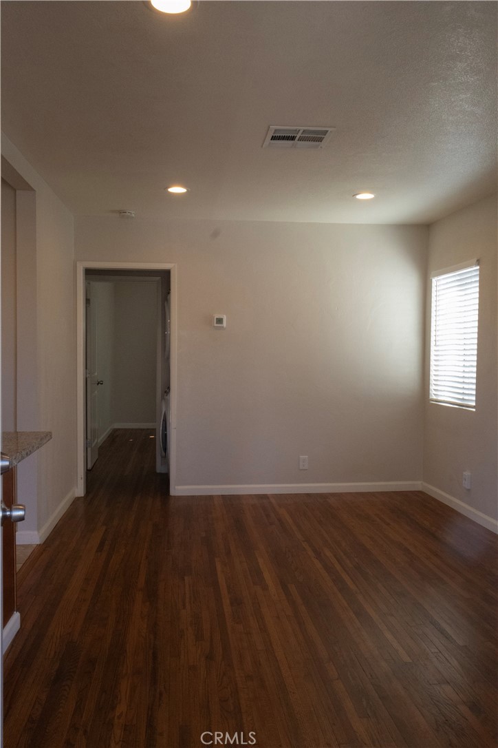 2412 Strong Avenue Commerce, CA 90040 - Photo 2 of 6 an empty room with wooden floor and windows