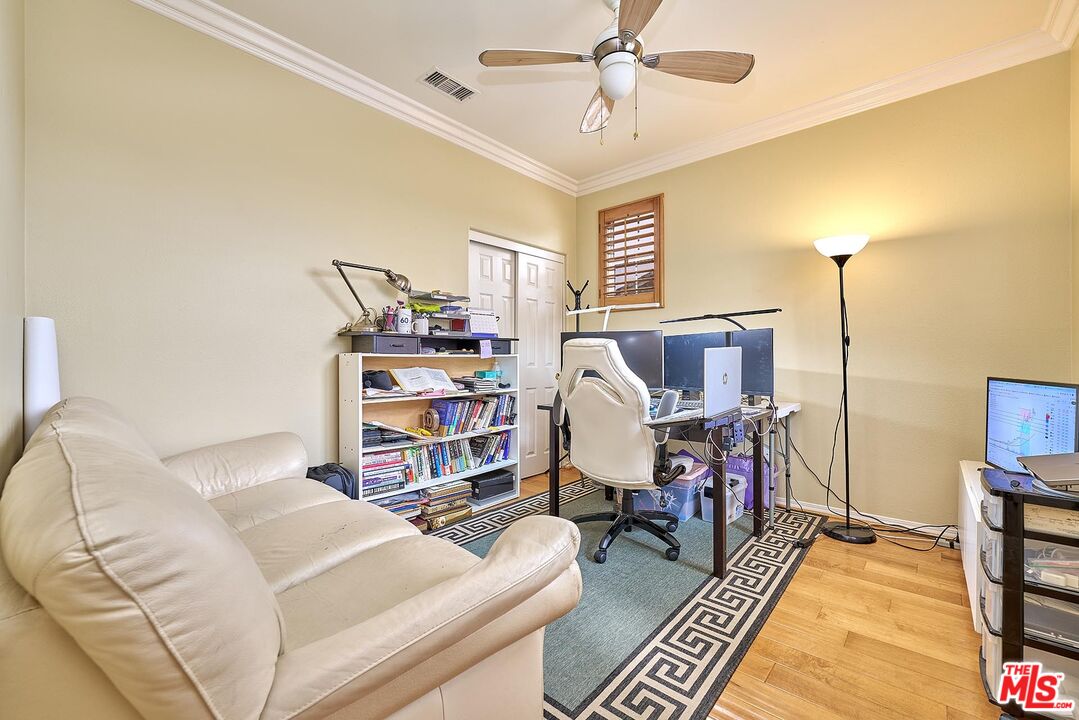 409 Spring Park Road Camarillo, CA 93012 - Photo 17 of 31 a living room with a couch and a bookshelf with wooden floor