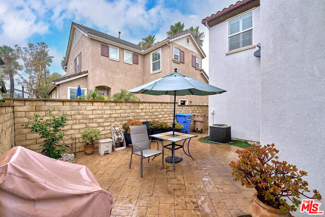 409 Spring Park Road Camarillo, CA 93012 - Photo 27 of 31 a patio with a table and chairs under an umbrella