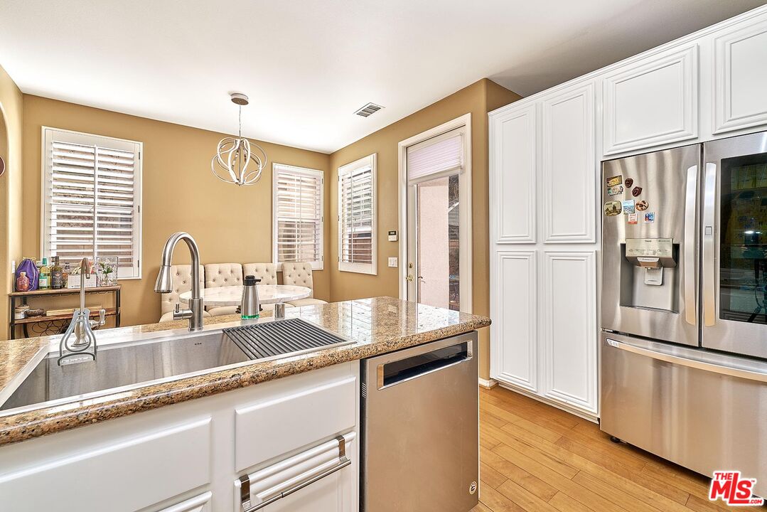 409 Spring Park Road Camarillo, CA 93012 - Photo 10 of 31 a kitchen with granite countertop a refrigerator and a sink