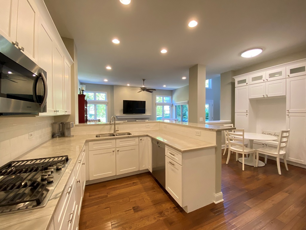 2428 Ridgewood Court Aurora, IL 60502 - Photo 11 of 40 a large kitchen with stainless steel appliances kitchen island granite countertop a stove and a sink