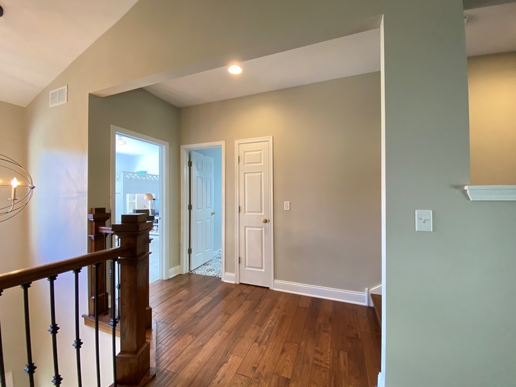 2428 Ridgewood Court Aurora, IL 60502 - Photo 23 of 40 a view of a hallway with wooden floor and a living room
