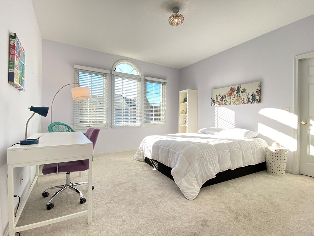 2428 Ridgewood Court Aurora, IL 60502 - Photo 25 of 40 a spacious bedroom with a bed window and table