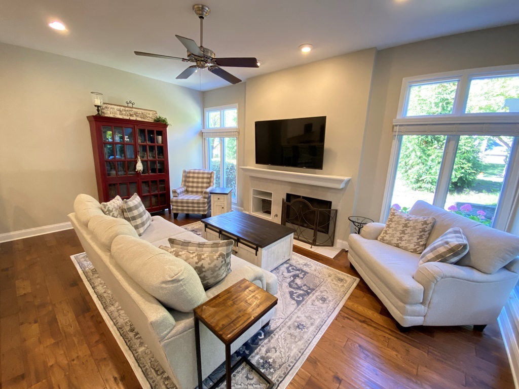 2428 Ridgewood Court Aurora, IL 60502 - Photo 7 of 40 a living room with furniture a flat screen tv and a fireplace