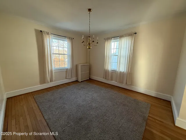 a view of a hallway with workspace and a window