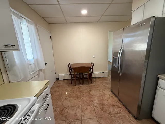 a kitchen with cabinets appliances a sink and a window