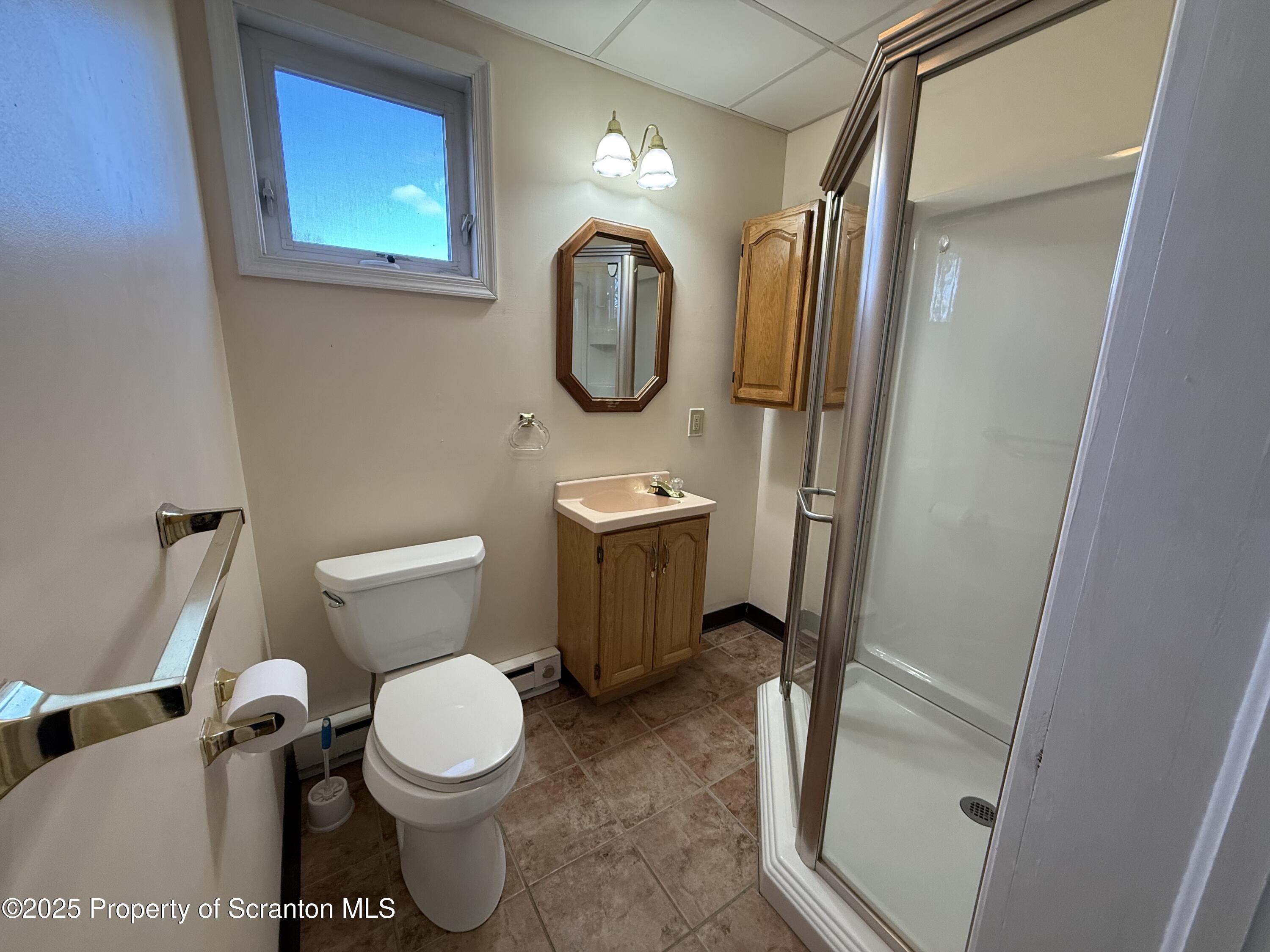 301 Monument Avenue Wyoming, PA 18644 - Photo 18 of 37 a bathroom with a toilet sink and mirror