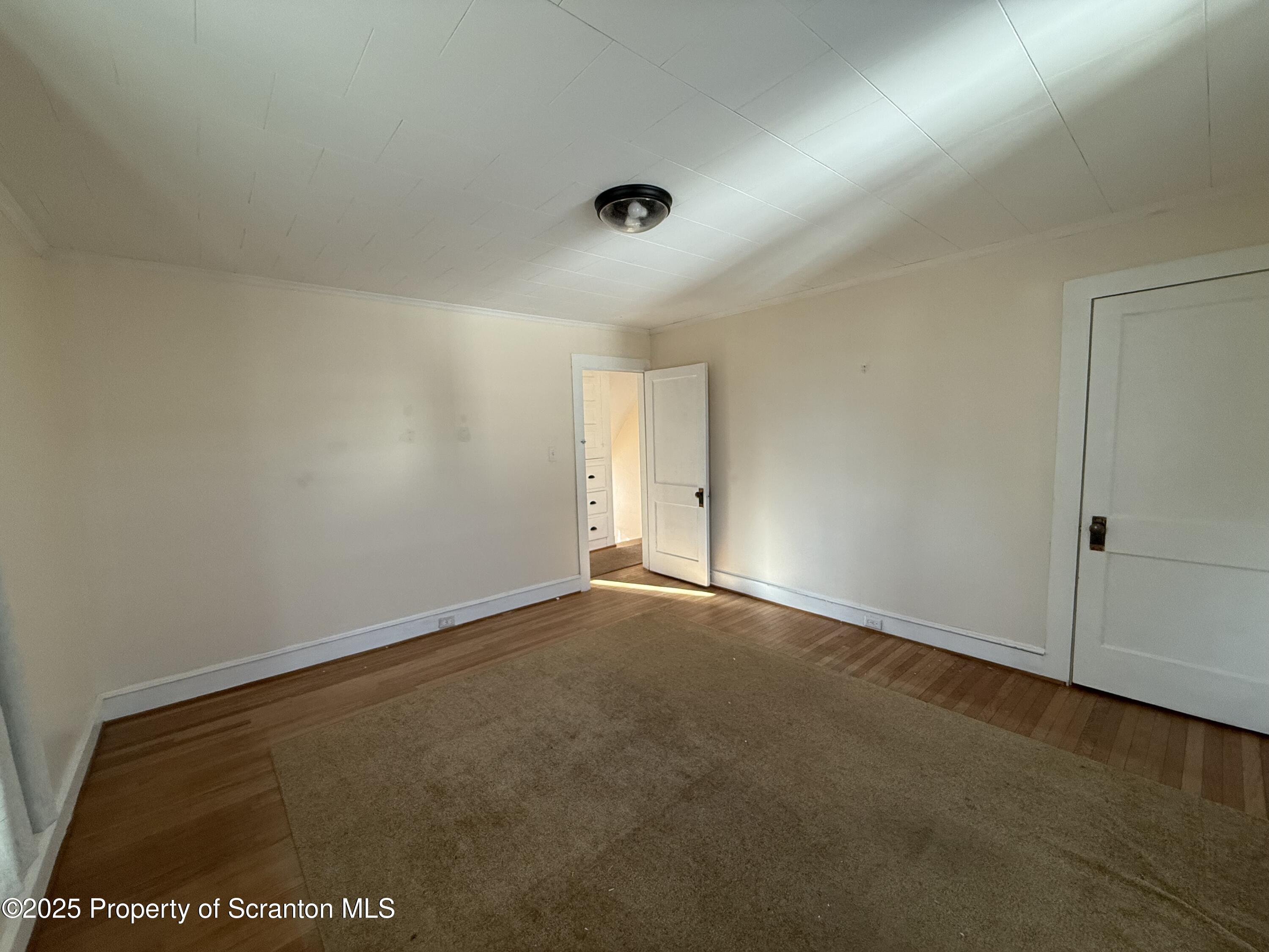301 Monument Avenue Wyoming, PA 18644 - Photo 23 of 37 an empty room with a empty space and window
