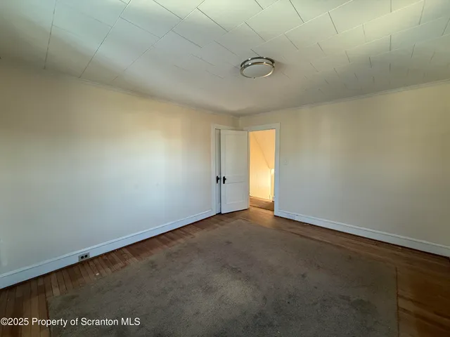 a spacious bathroom with a toilet sink and mirror