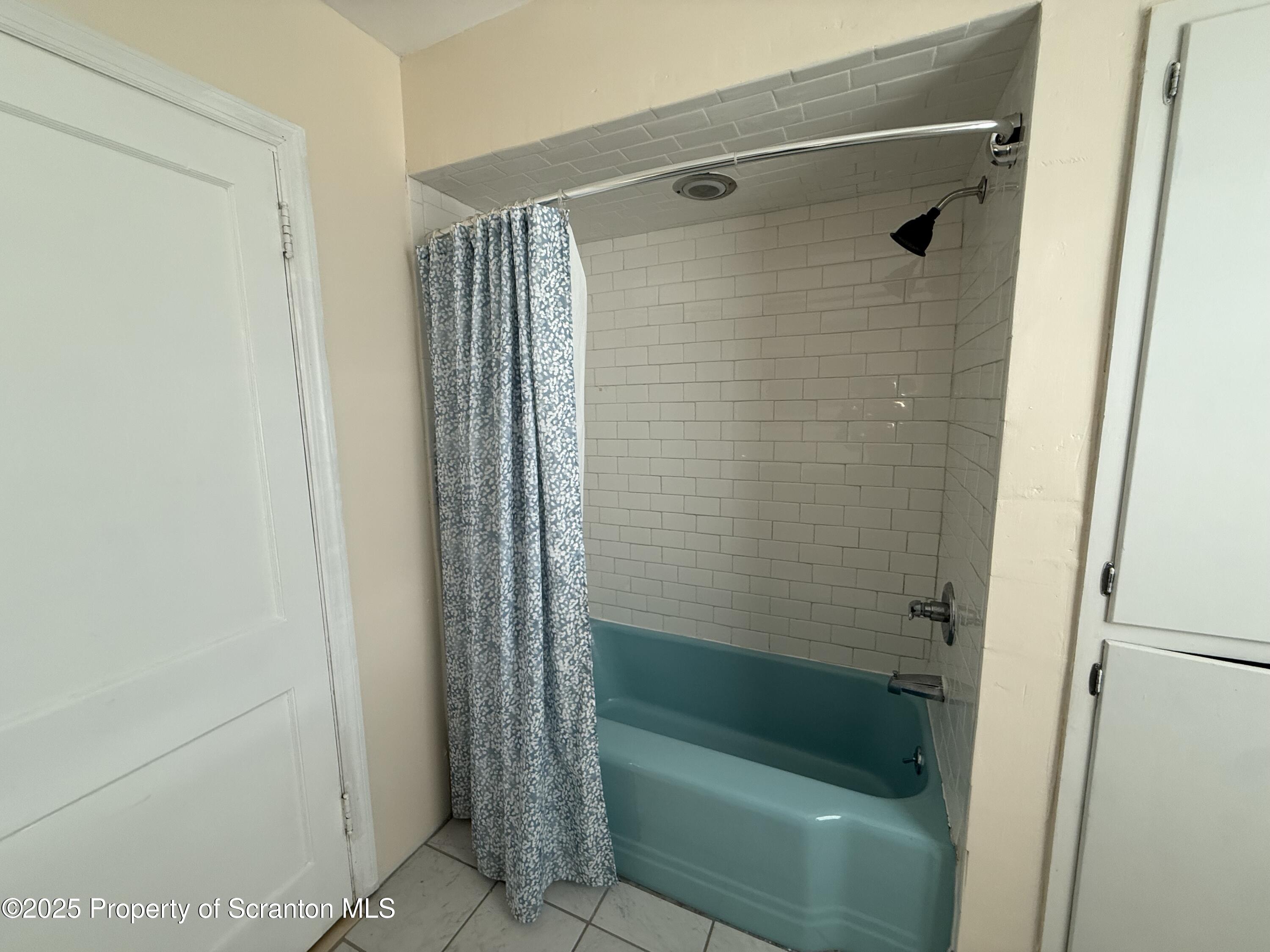 301 Monument Avenue Wyoming, PA 18644 - Photo 28 of 37 a bathroom with a shower and a sink