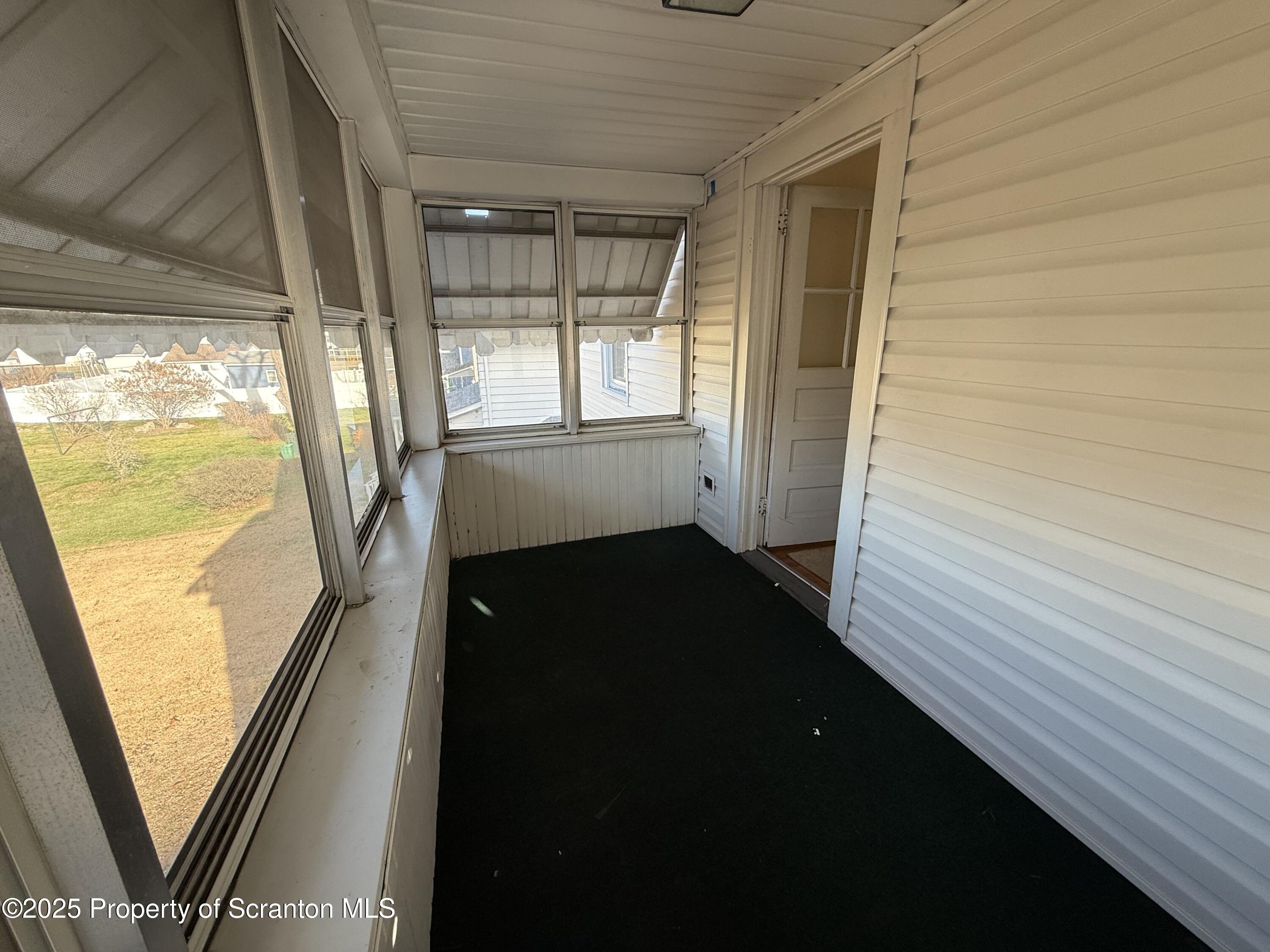 301 Monument Avenue Wyoming, PA 18644 - Photo 31 of 37 a view of a balcony with wooden floor and door