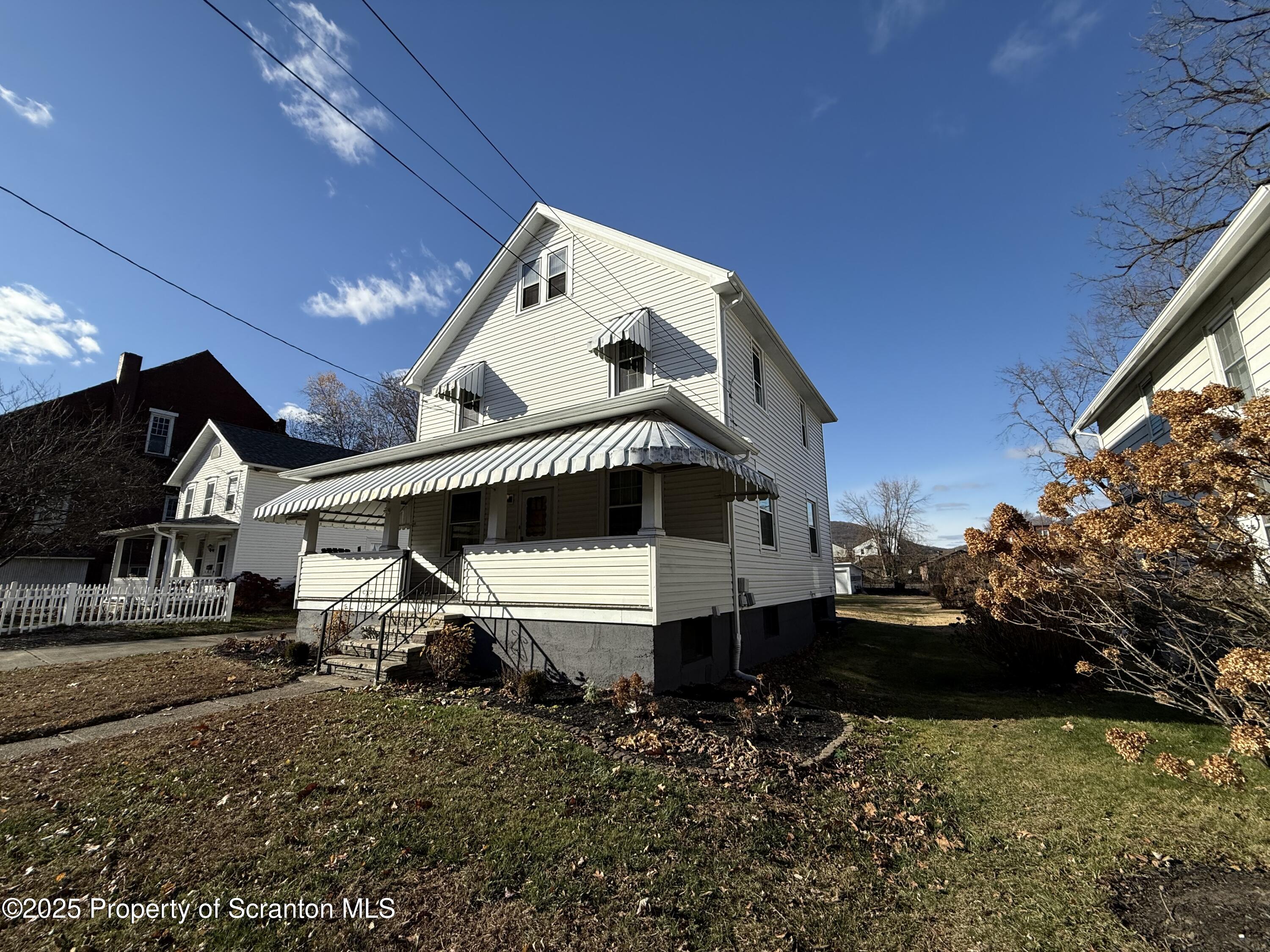 301 Monument Avenue Wyoming, PA 18644 - Photo 35 of 37 a front view of a house with a yard