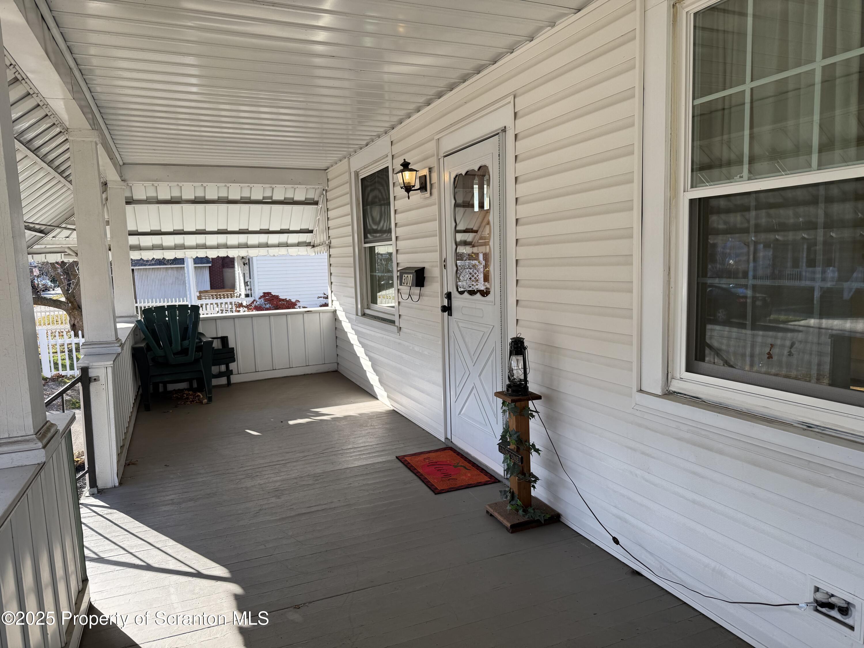 301 Monument Avenue Wyoming, PA 18644 - Photo 6 of 37 a room with gym equipment and a large window