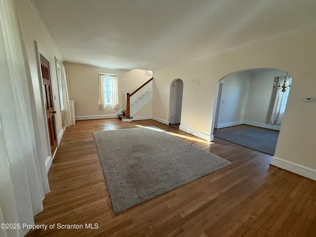 an empty room with windows and cabinet