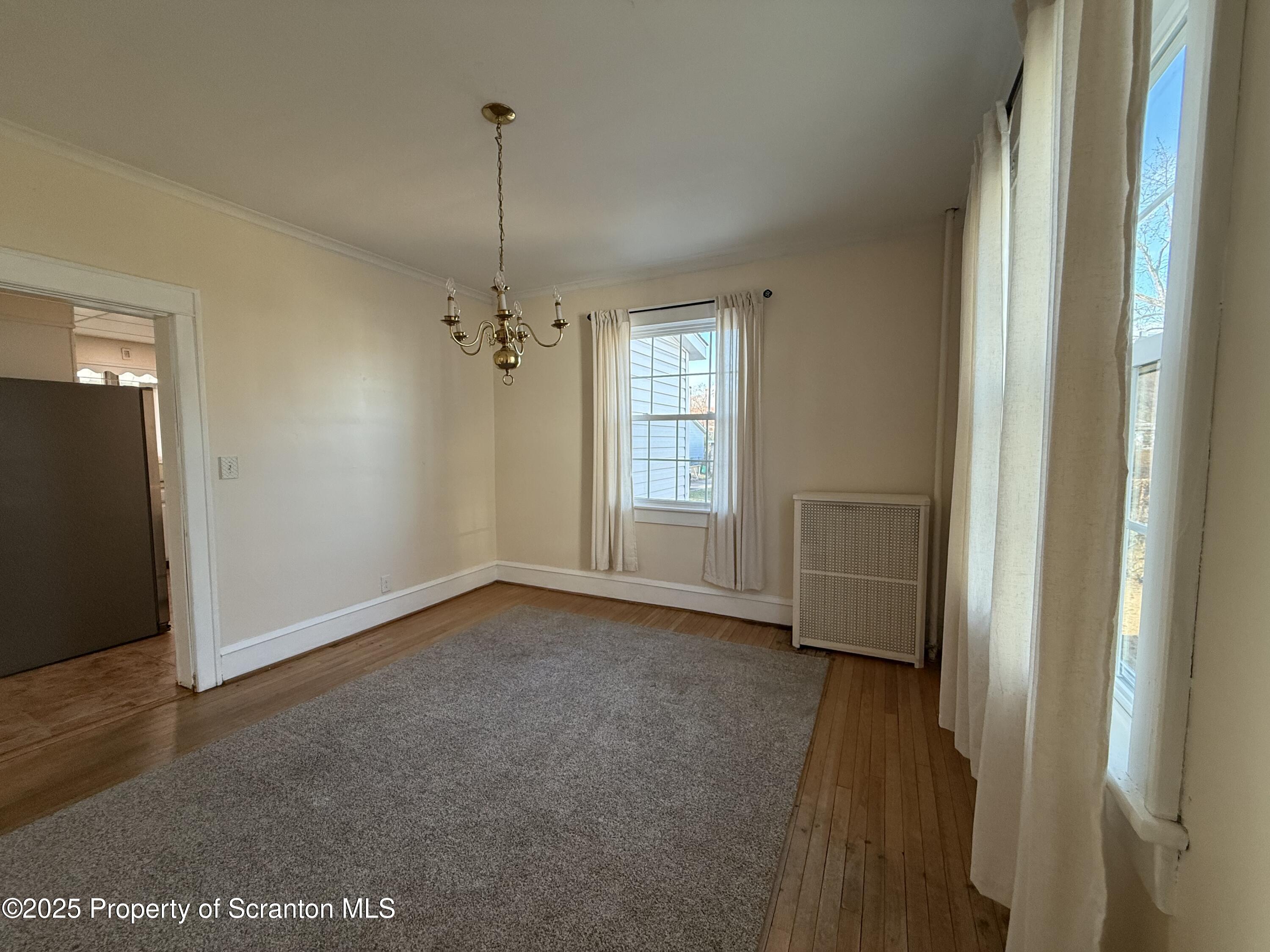 301 Monument Avenue Wyoming, PA 18644 - Photo 10 of 37 an empty room with windows and cabinet