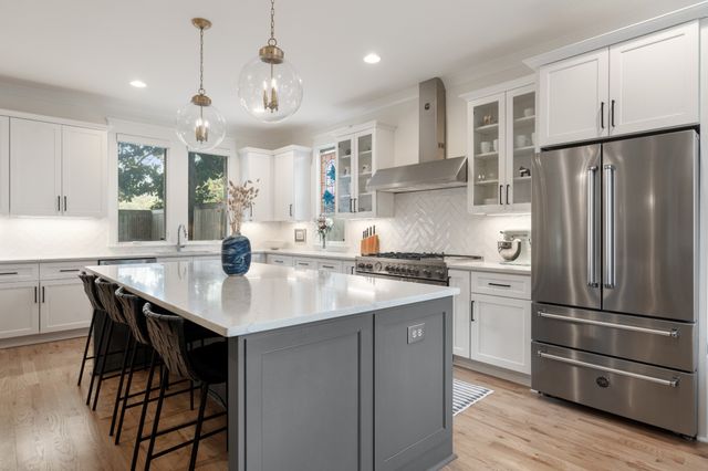 a living room with furniture chandelier and view of kitchen