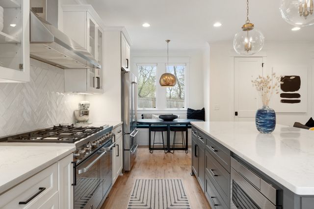 a spacious bedroom with a bed and a chandelier