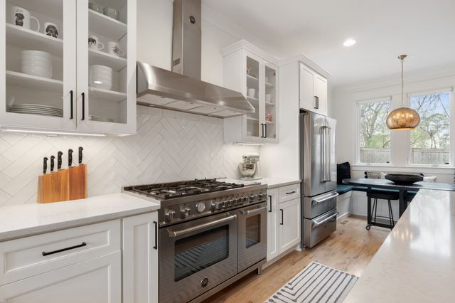 a bathroom with a granite countertop sink a mirror and a shower