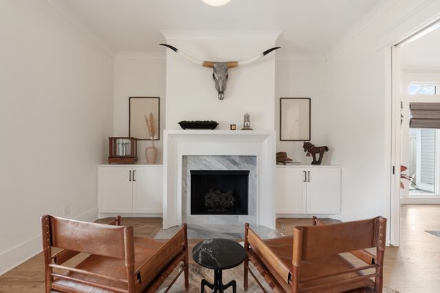 a view of a dining room with furniture and chandelier