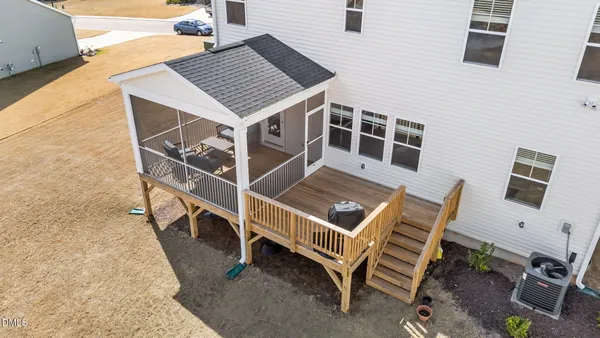 a view of a white house with a yard and sitting area