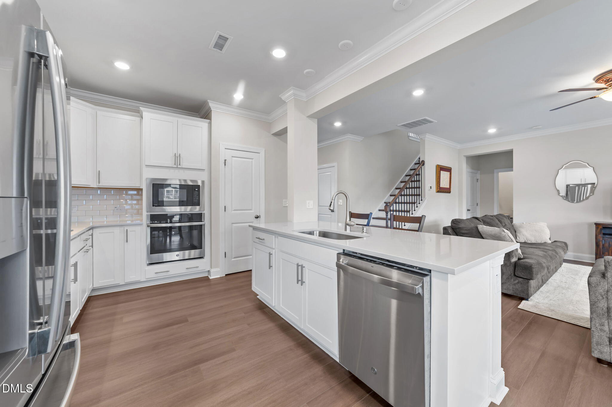 103 Ellsworth Court Garner, NC 27529 - Photo 19 of 48 a large kitchen with stainless steel appliances lot of white cabinets and wooden floors
