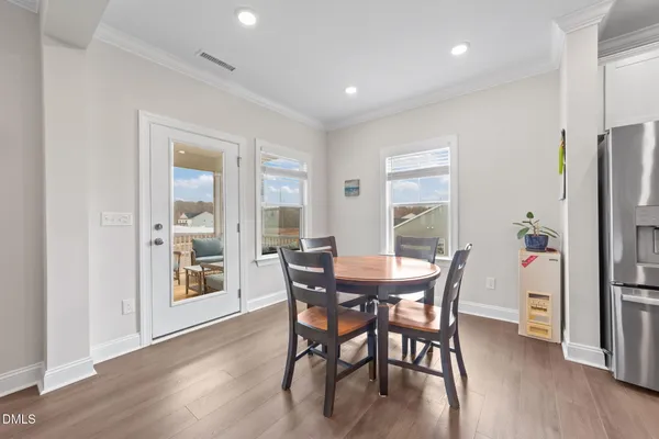 a kitchen with white cabinets and sink