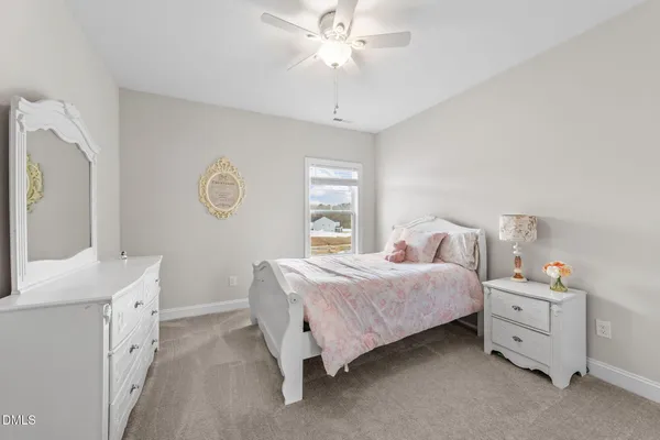 a bathroom with a double vanity sink toilet and a mirror