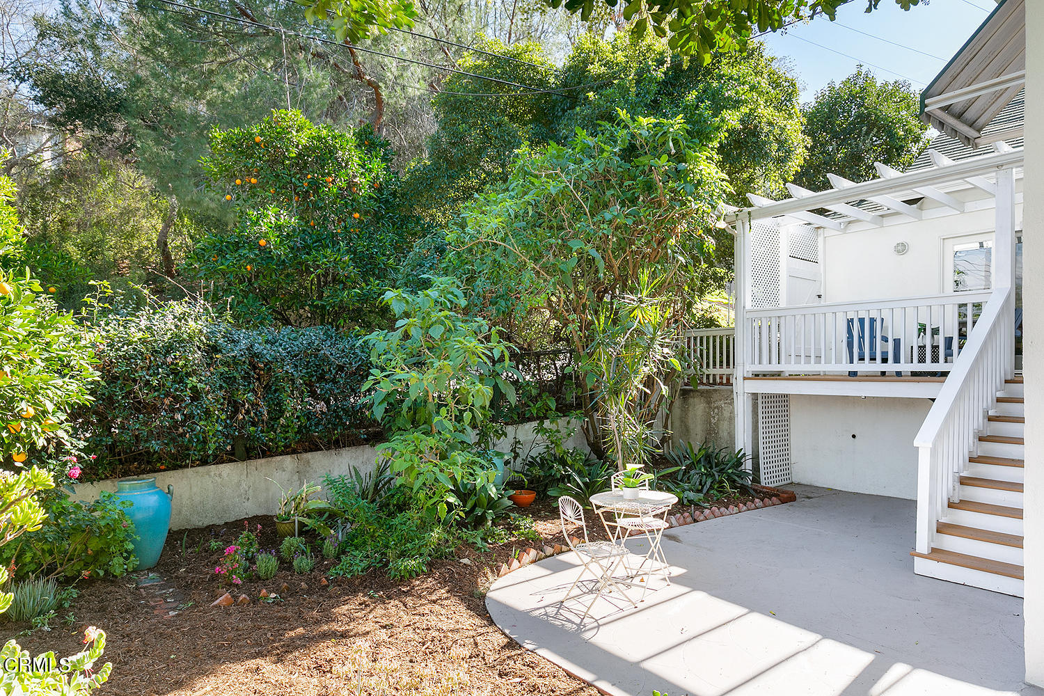 98 Pine Crest Drive South Pasadena, CA 91030 - Photo 31 of 33 a view of a patio with a table and chairs with wooden fence and plants