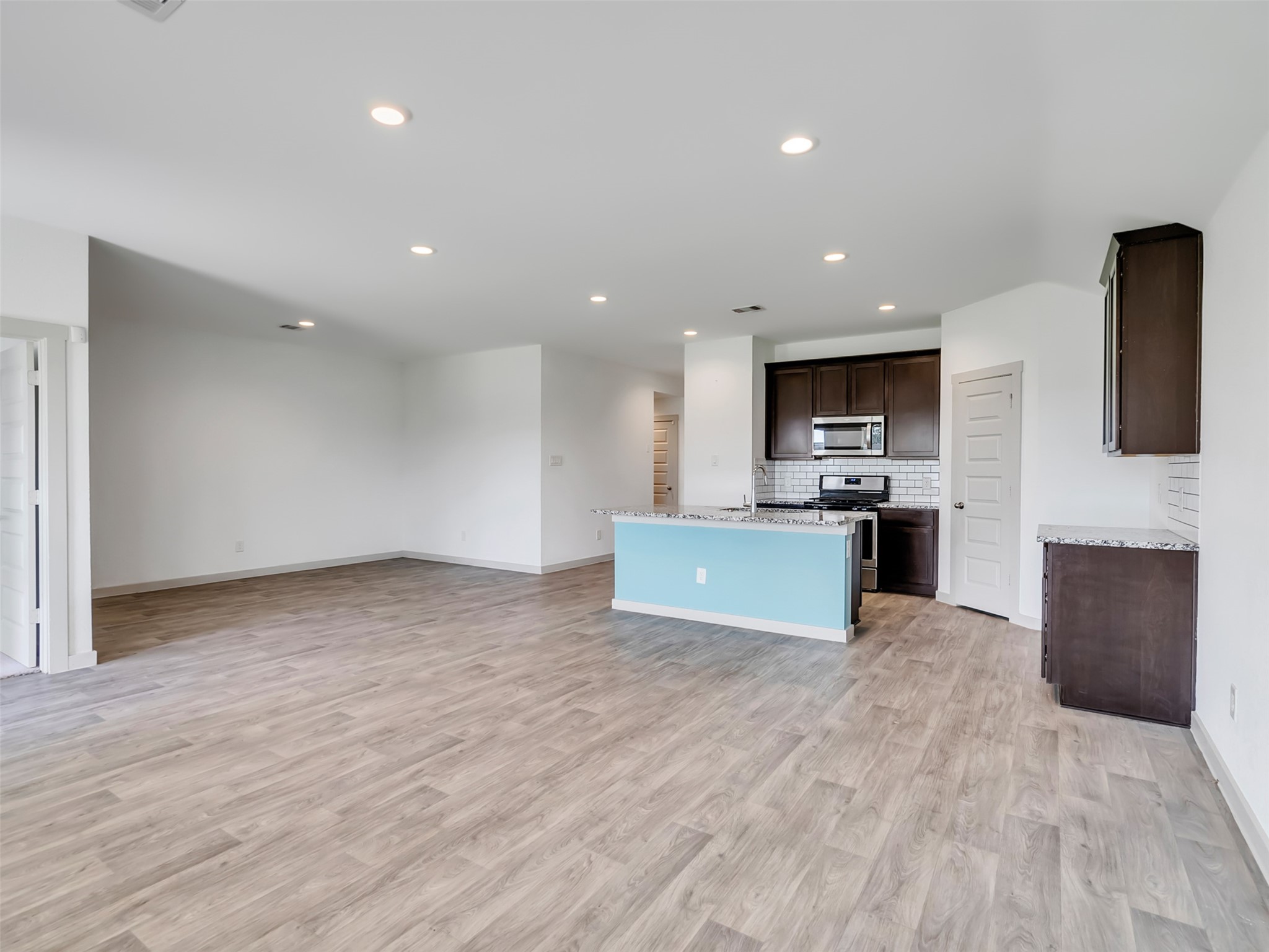 8003 Alcott Forest Lane Rosharon, TX 77583 - Photo 20 of 41 a view of kitchen with kitchen island granite countertop wooden cabinets and stainless steel appliances