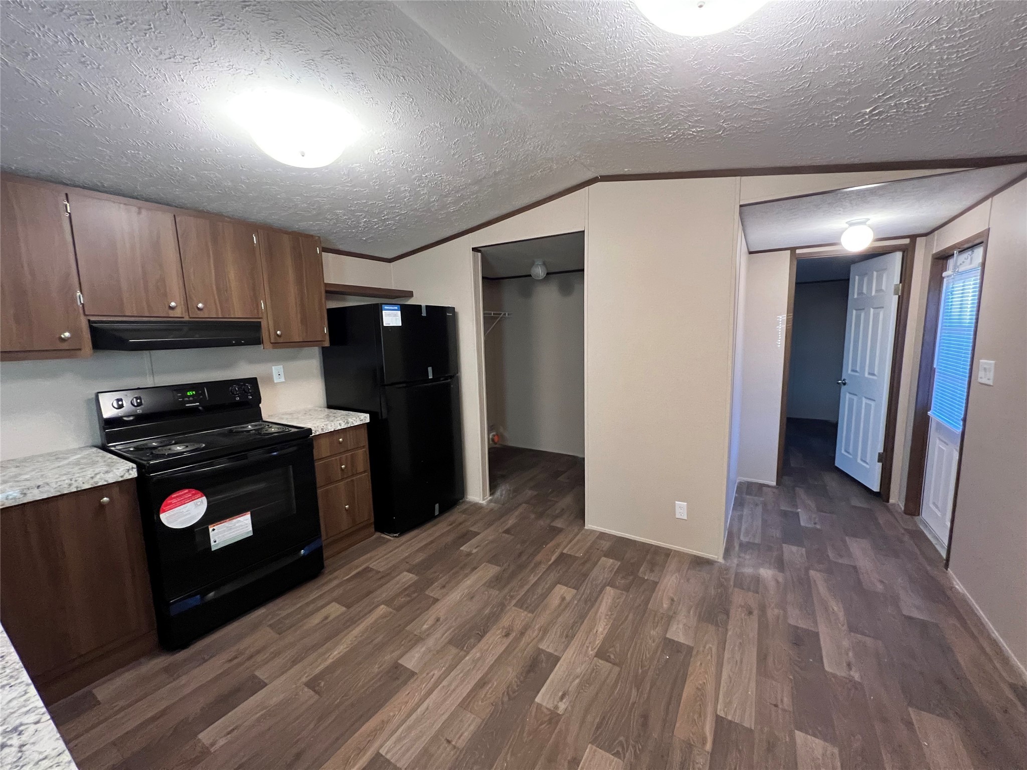 13910 Anchor Court Willis, TX 77318 - Photo 7 of 12 a kitchen with a refrigerator stove and wooden cabinets