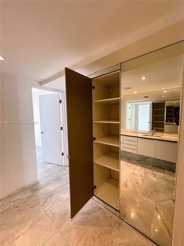 a bathroom with a granite countertop sink and a large mirror