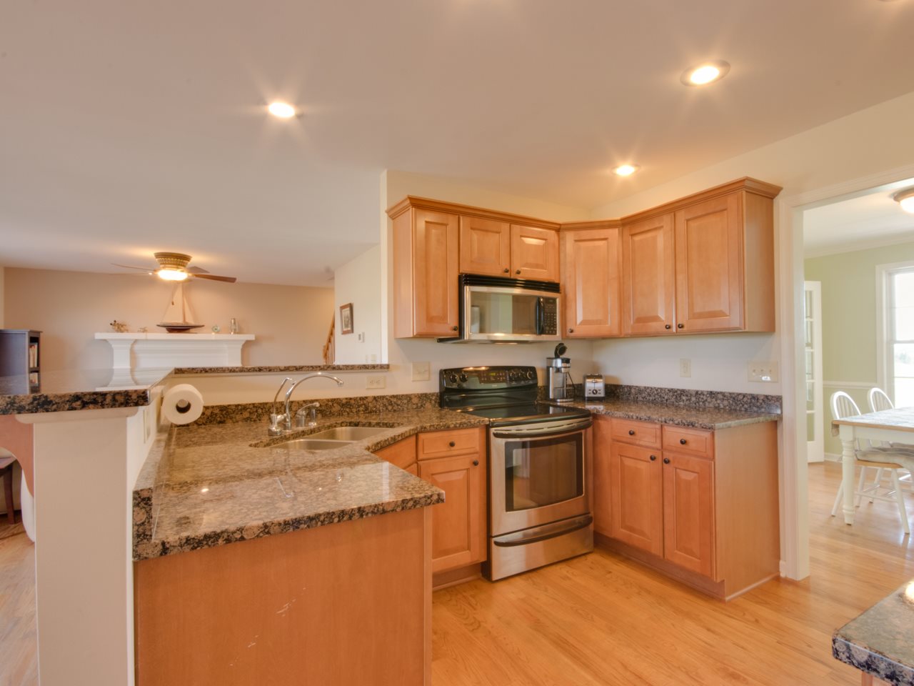 134 Bailey Road Fort Defiance, VA 24437 - Photo 18 of 42 a kitchen with stainless steel appliances granite countertop a stove top oven a sink dishwasher and a refrigerator with wooden floor