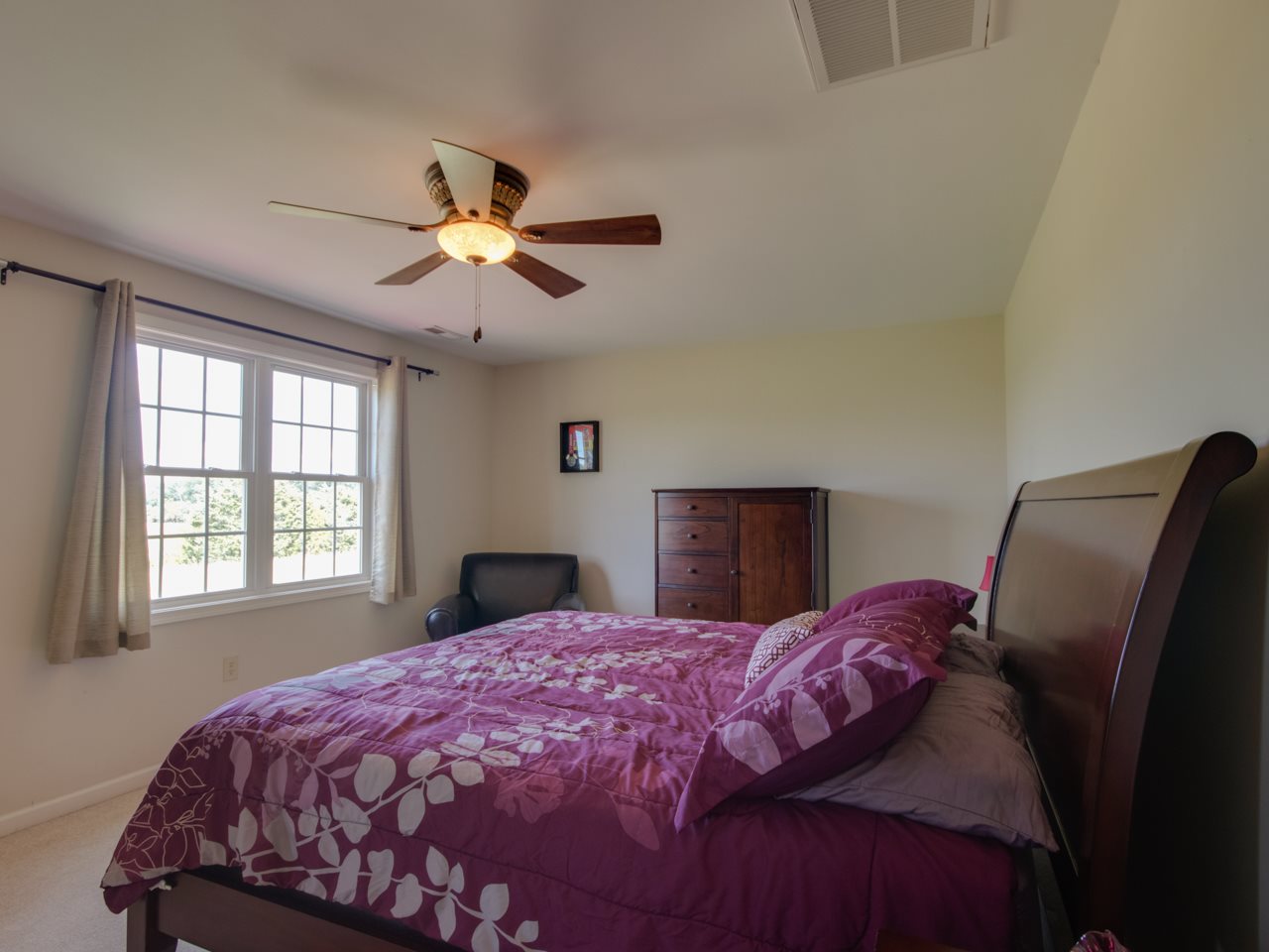 134 Bailey Road Fort Defiance, VA 24437 - Photo 30 of 42 a bedroom with a bed and a chandelier