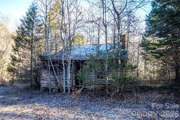 a view of a house with a yard and tree s