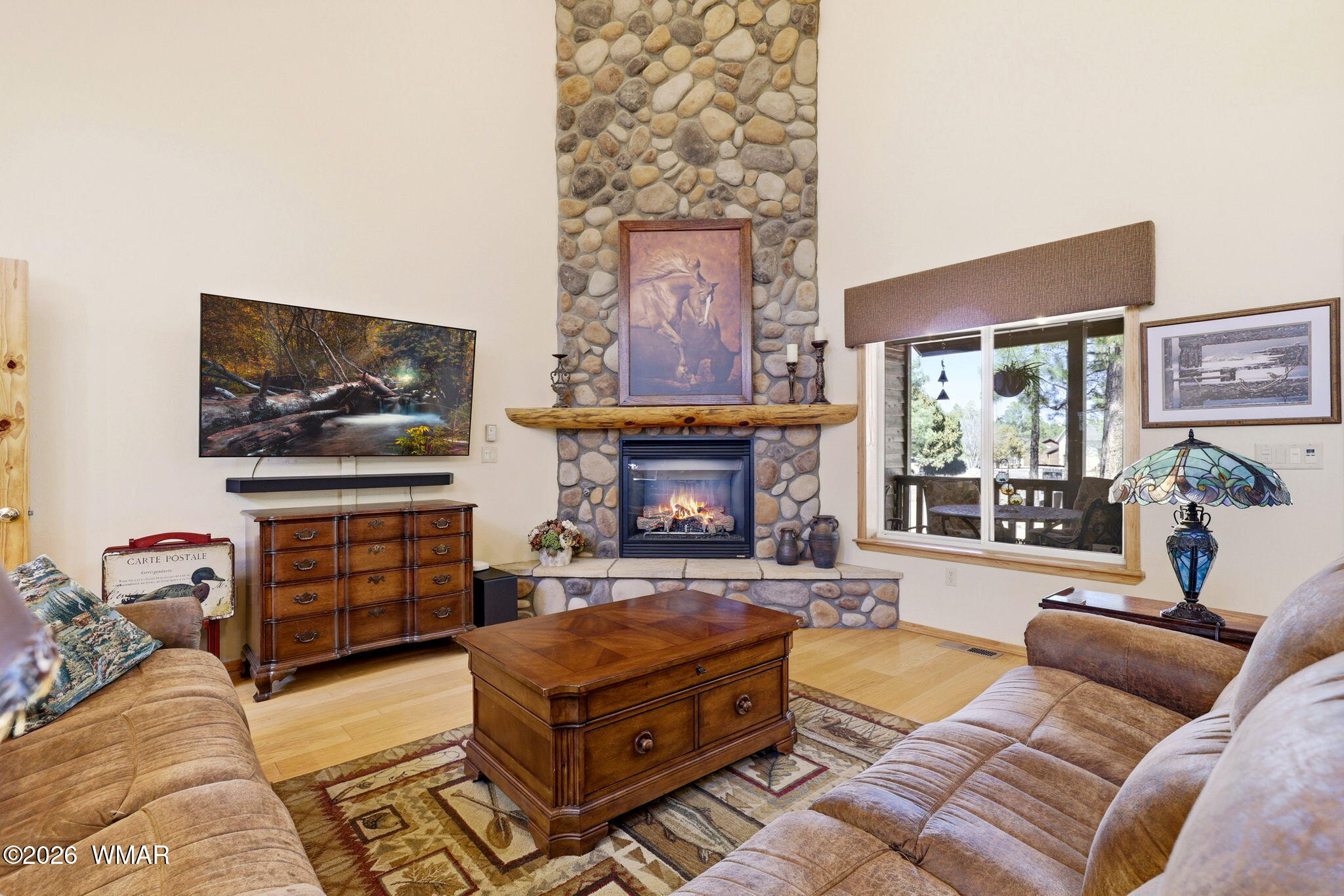 826 Pine Creek Circle Lakeside, AZ 85929 - Photo 3 of 65 a living room with furniture a flat screen tv and a fireplace