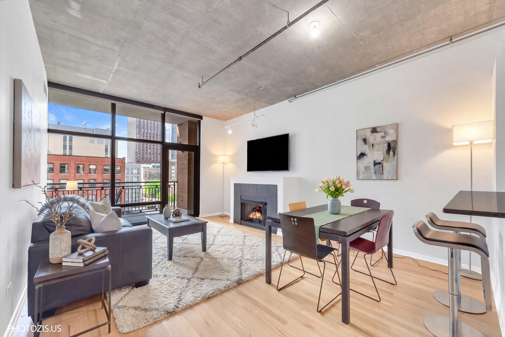 520 South State Street, Unit 712 Chicago, IL 60605 - Photo 6 of 28 a living room with furniture a flat screen tv and a large window