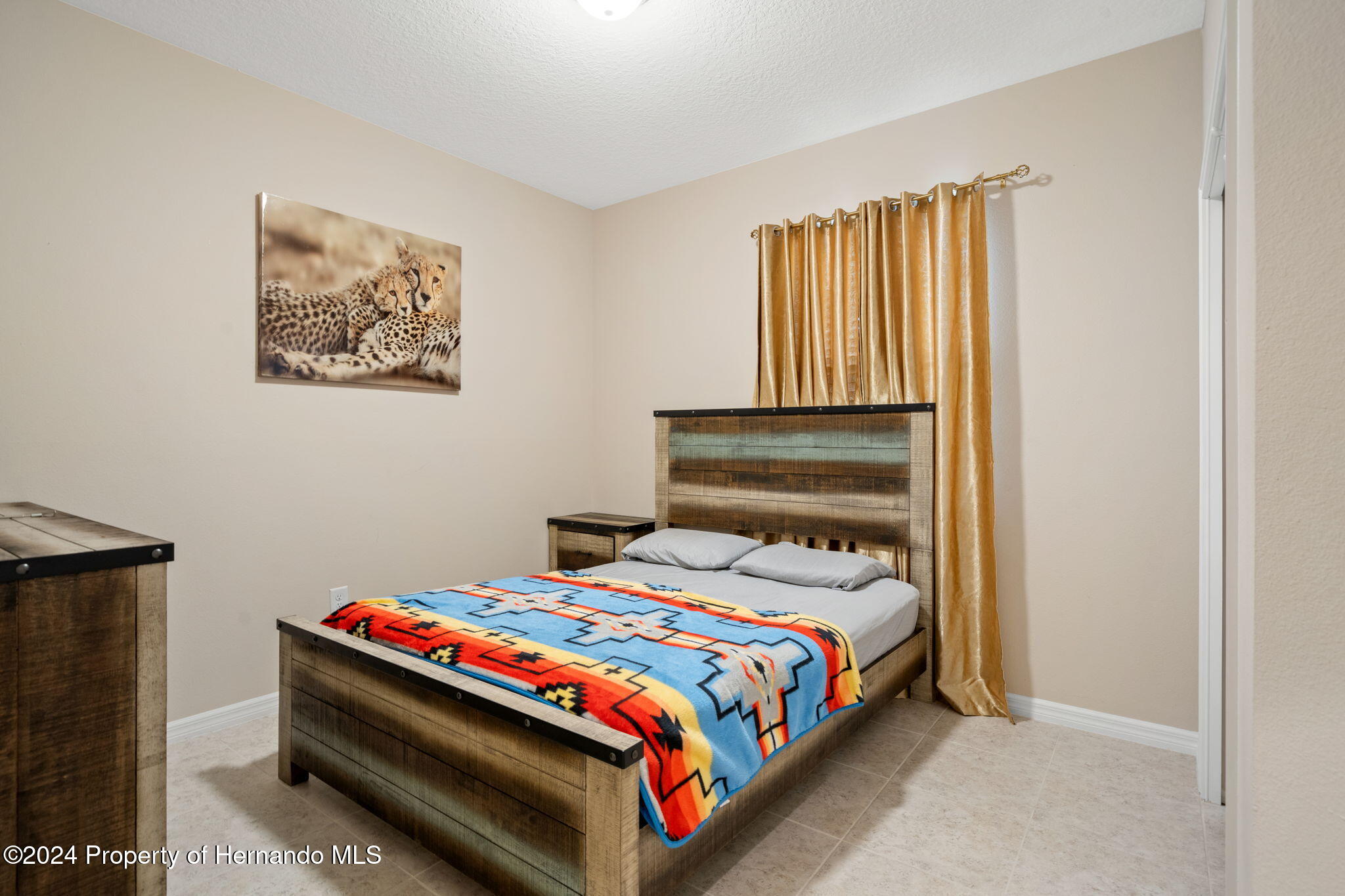 954 Old Windsor Way Spring Hill, FL 34609 - Photo 14 of 32 a bedroom with a bed and wooden floor