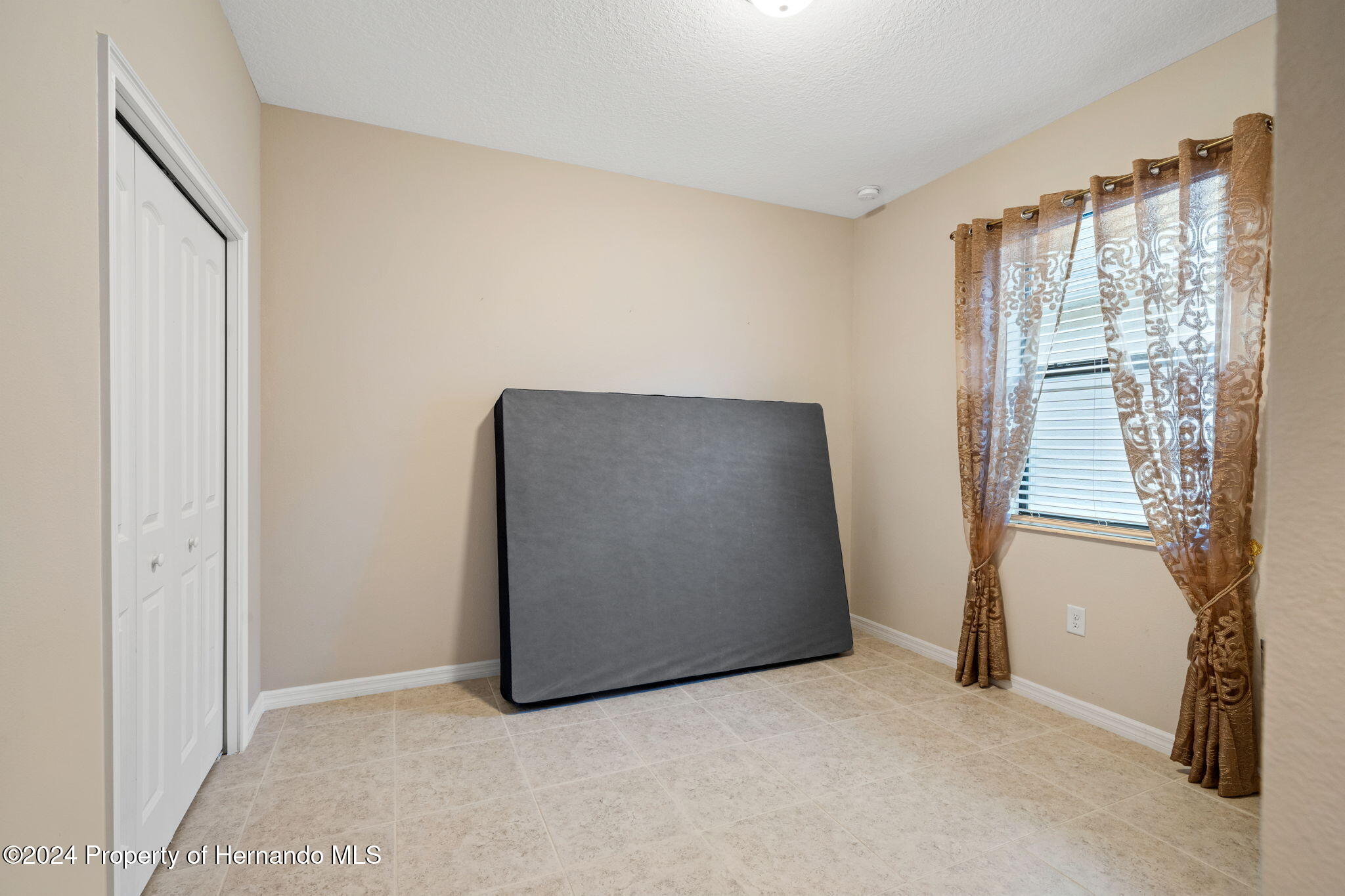 954 Old Windsor Way Spring Hill, FL 34609 - Photo 18 of 32 an empty room with windows