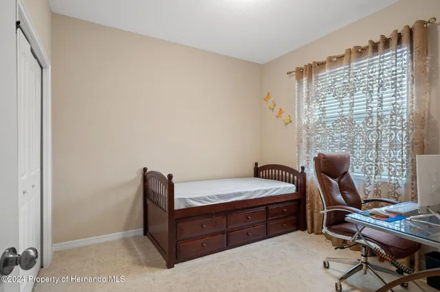 a bedroom with a bed and a couch