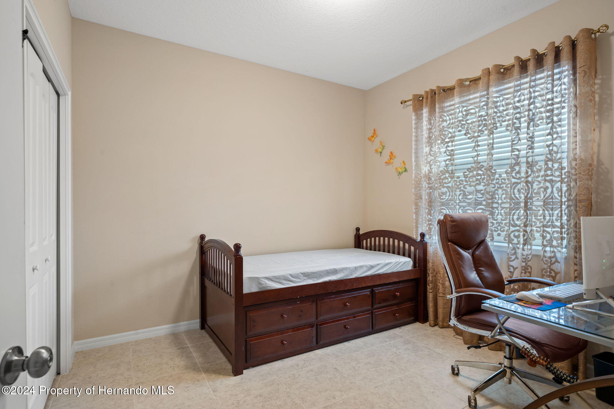 954 Old Windsor Way Spring Hill, FL 34609 - Photo 19 of 32 a bedroom with a bed and a window