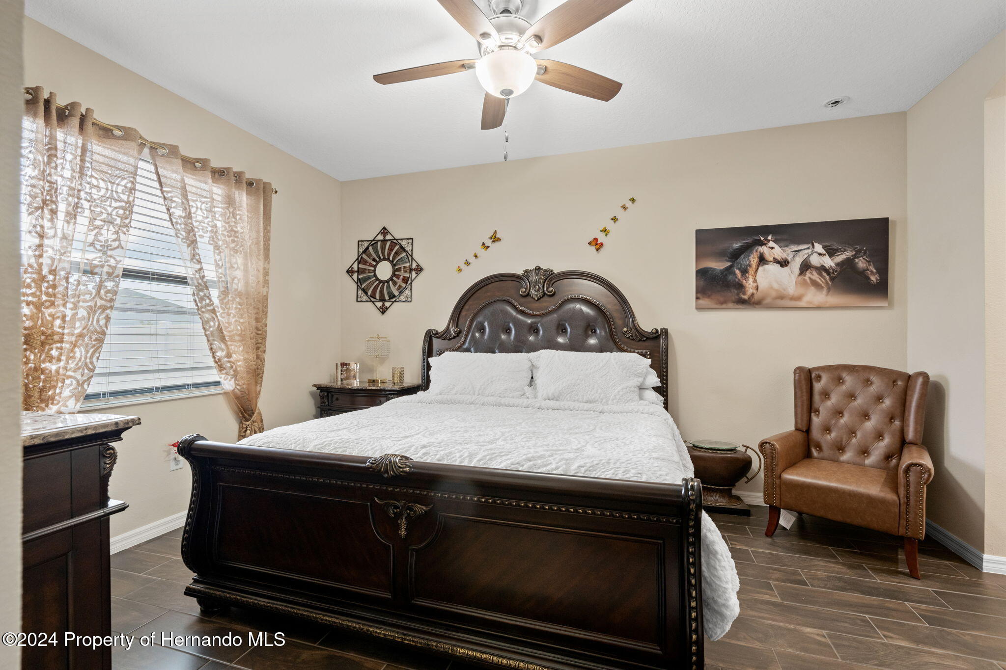 954 Old Windsor Way Spring Hill, FL 34609 - Photo 20 of 32 a bedroom with a bed and a couch