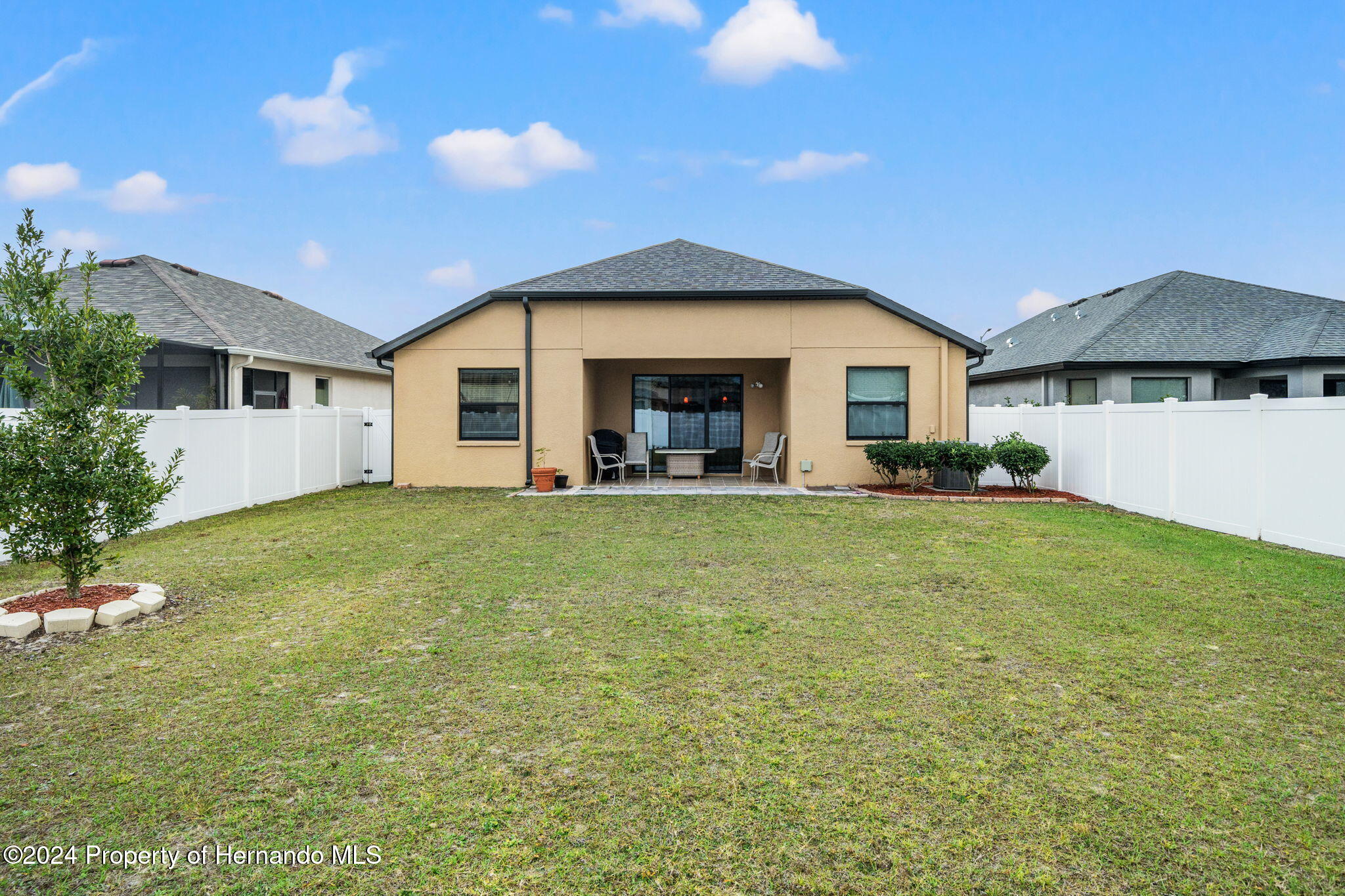 954 Old Windsor Way Spring Hill, FL 34609 - Photo 27 of 32 a front view of a house with garden