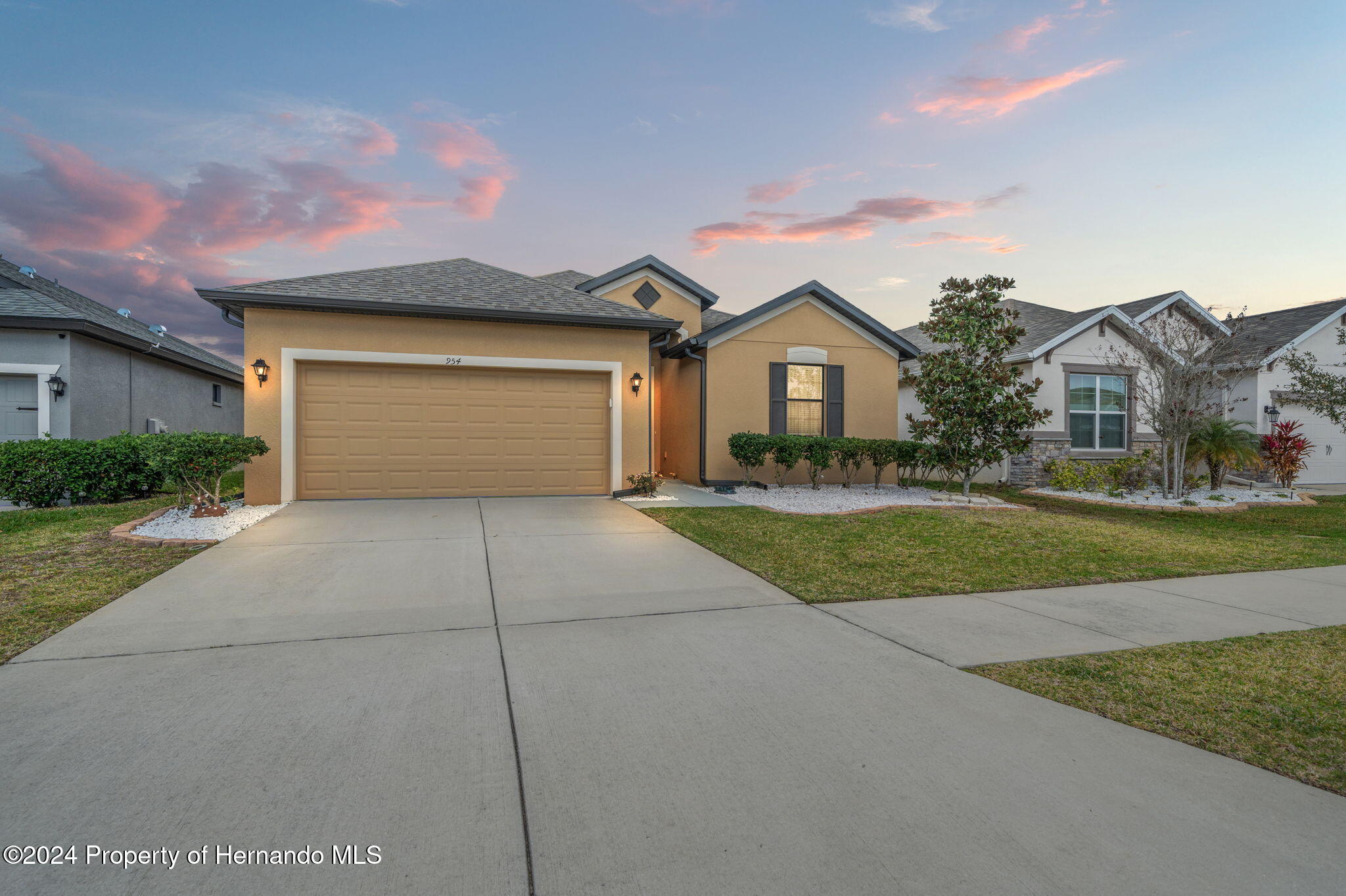 954 Old Windsor Way Spring Hill, FL 34609 - Photo 29 of 32 a front view of a house with a yard and garage