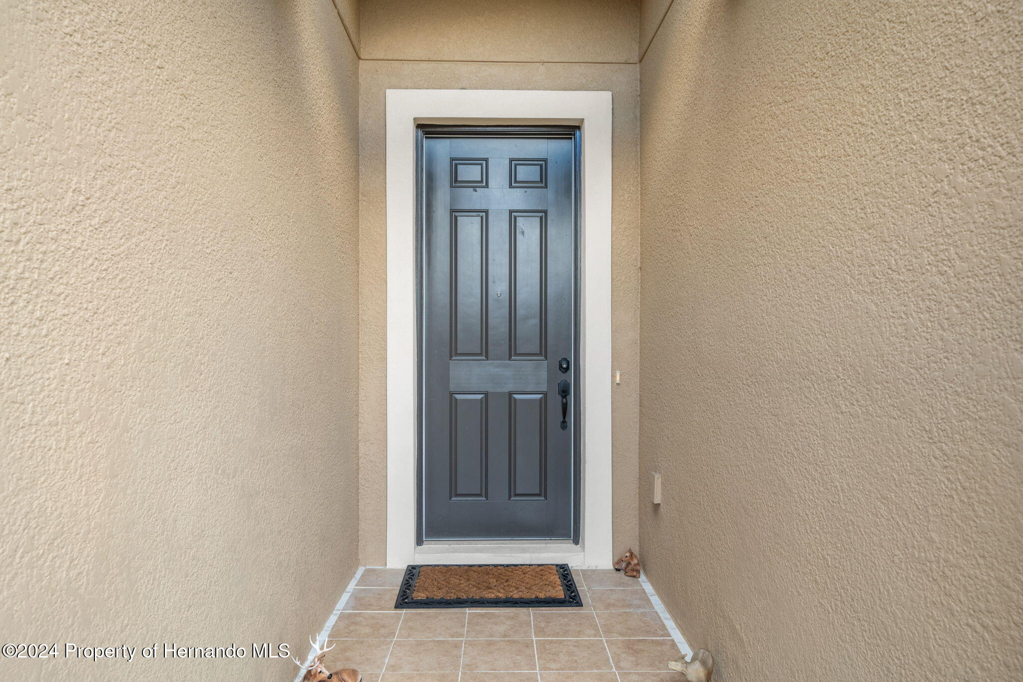 954 Old Windsor Way Spring Hill, FL 34609 - Photo 3 of 32 a view of a hallway with wooden floor