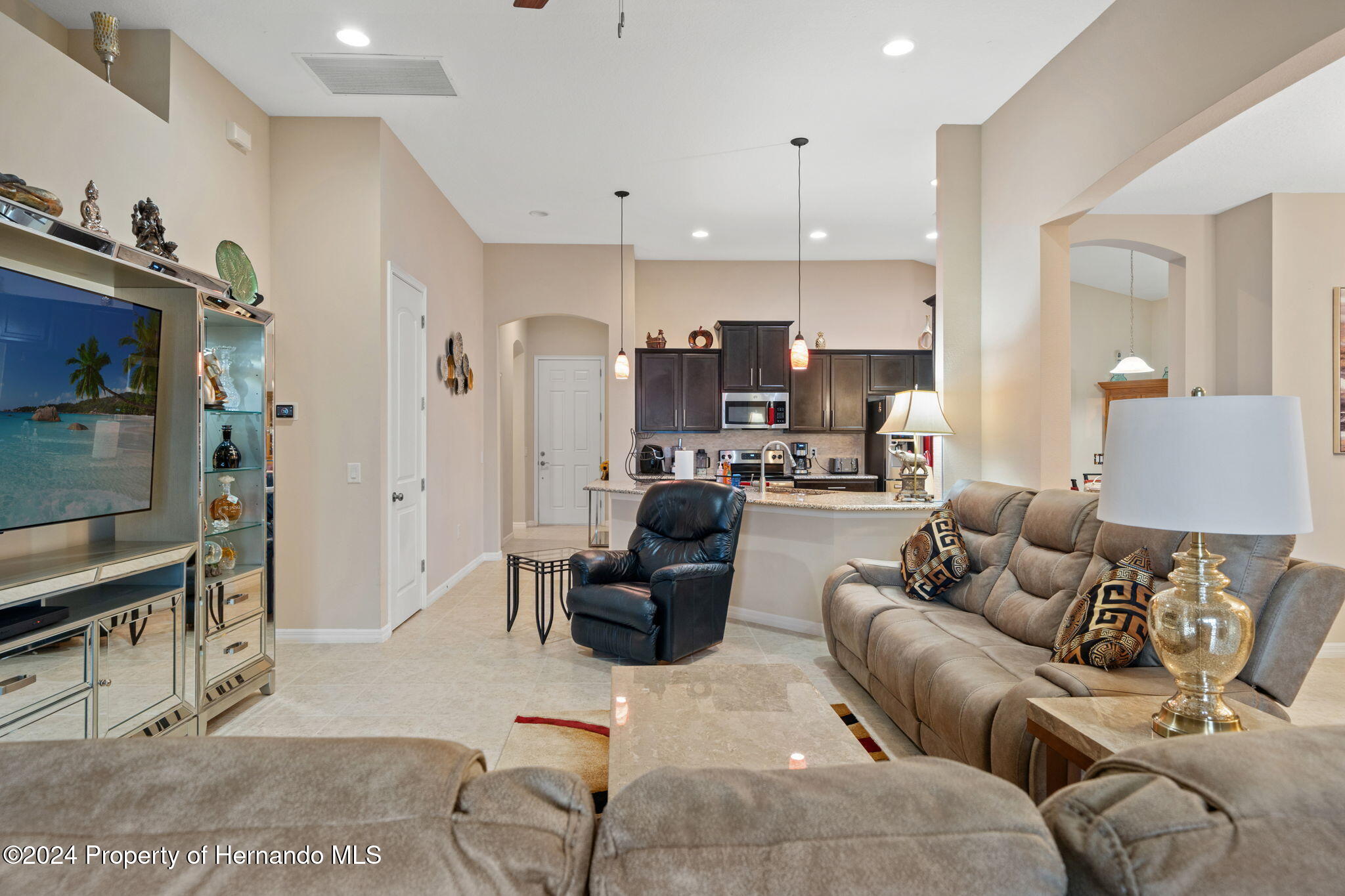 954 Old Windsor Way Spring Hill, FL 34609 - Photo 5 of 32 a living room with furniture and a wooden floor
