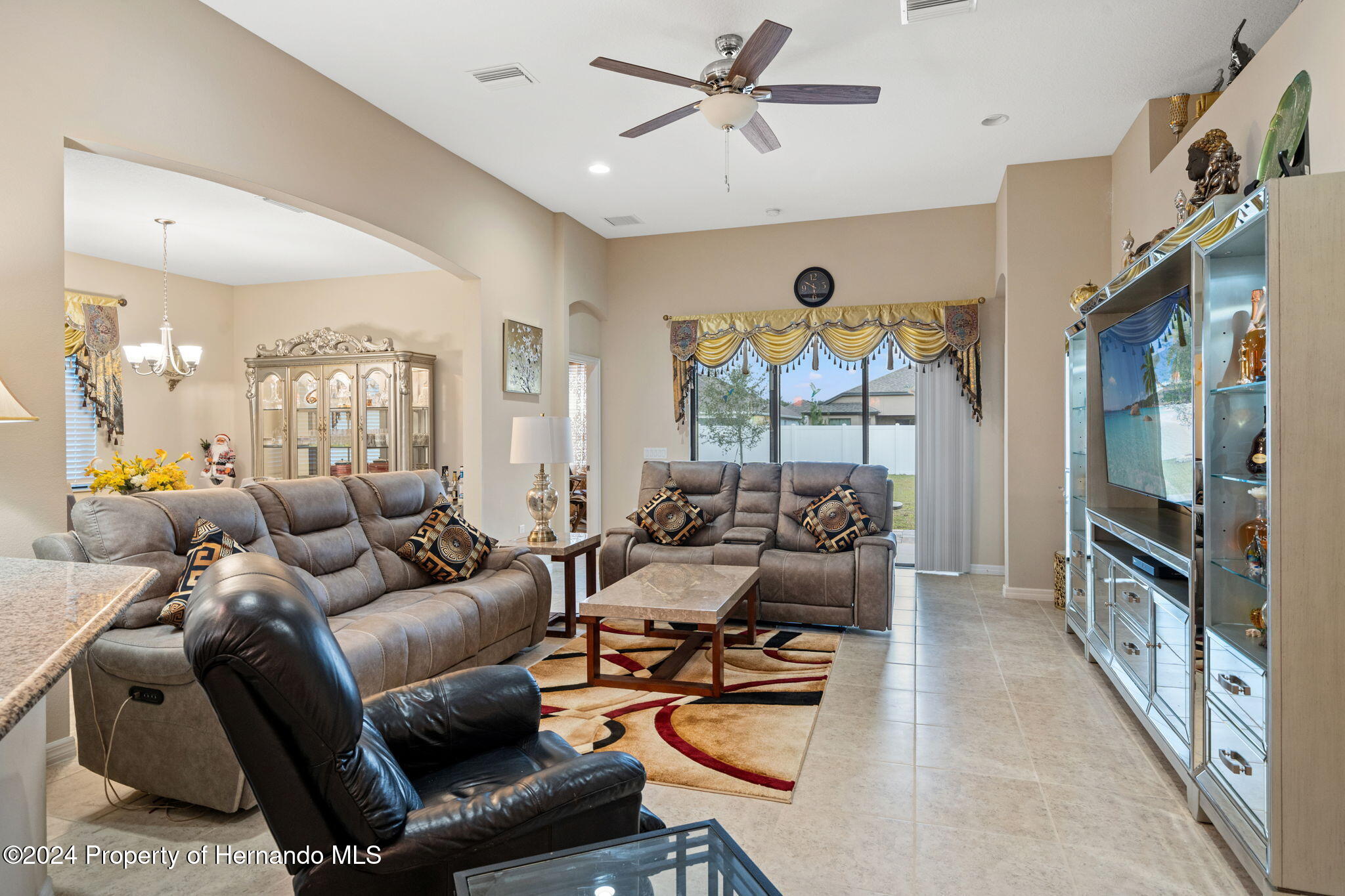 954 Old Windsor Way Spring Hill, FL 34609 - Photo 6 of 32 a living room with furniture and a large window